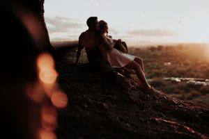 A couple sitting on a mountain