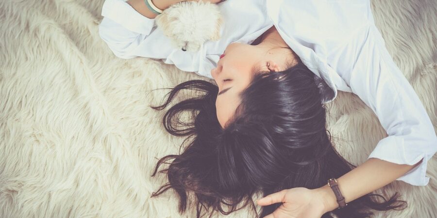 Be kinder to yourself. Woman and dog relaxing.