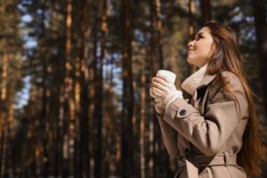 Woman who is overcoming overload by visiting the forest