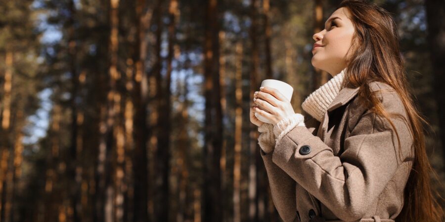 Woman who is overcoming overload by visiting the forest