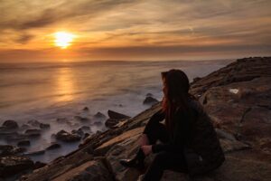 woman setting goals on the beach