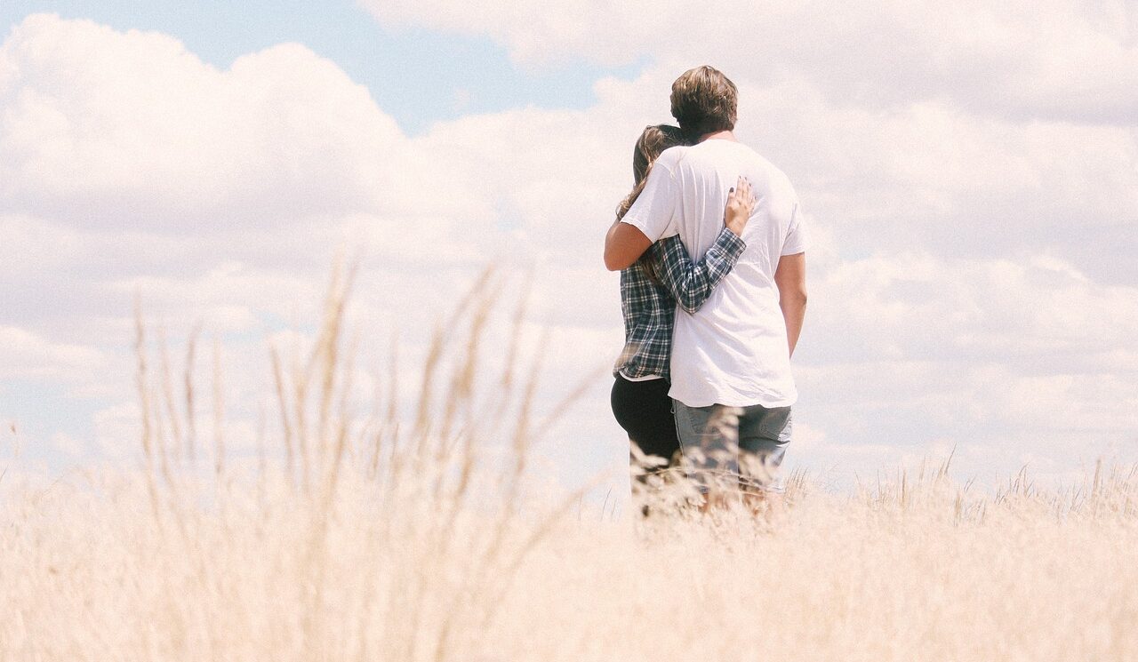 couple standing in field